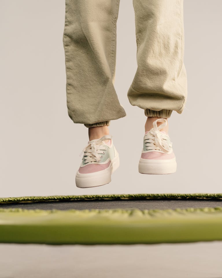 Close-up of a person jumping on a trampoline, showcasing dynamic motion and fun energy.